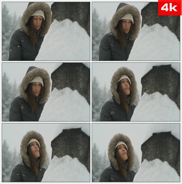 4K0012站在暴风雪里的美女向上眺望 高清实拍视频素材