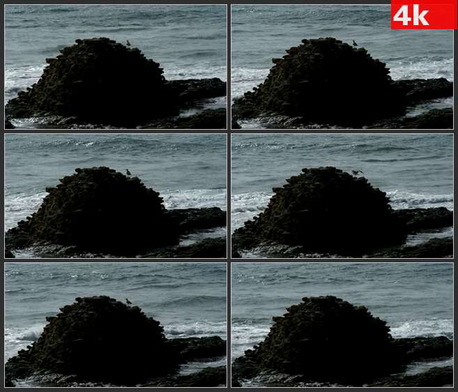 4K0654波浪拍打着黑色的岩石 高清实拍视频素材