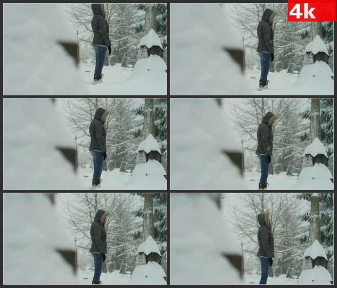 4K0670暴雪中站在墓碑前的美女 高清实拍视频素材