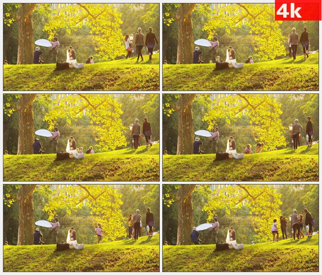 4K0934公园婚纱摄影师婚纱照拍摄草地夕阳游人高清实拍视频素材
